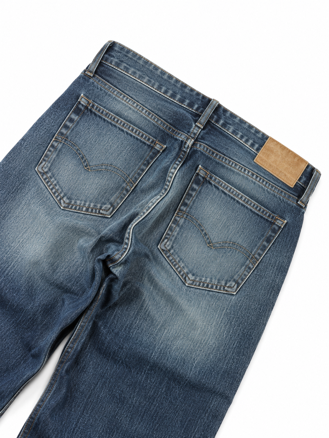 Halden Wide Straight — back pocket detail with a blank leather patch on faded blue denim