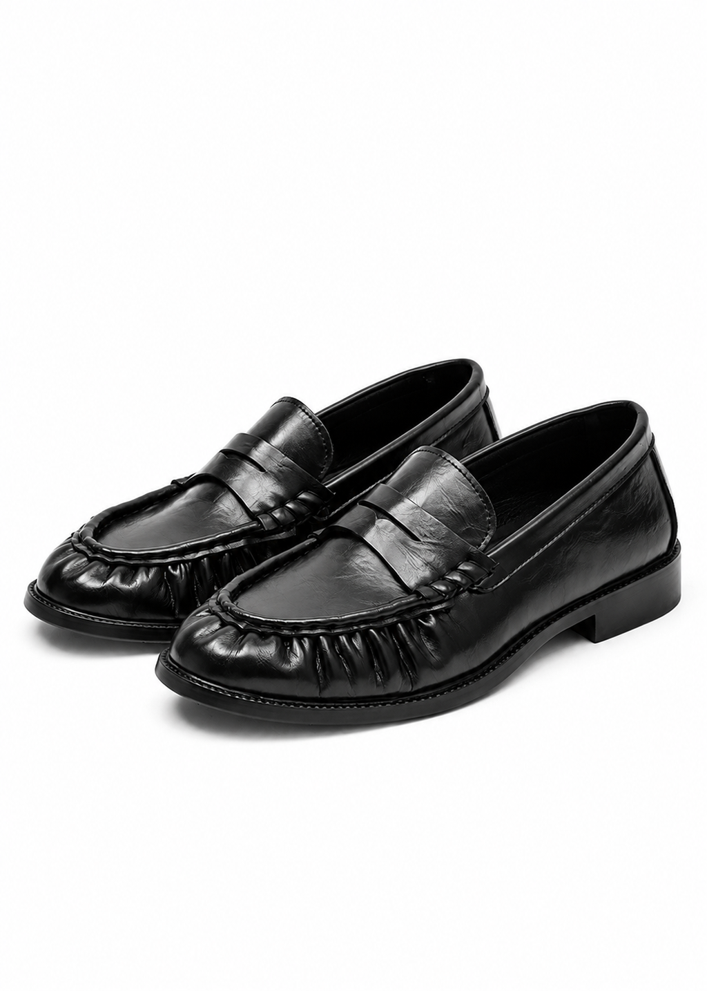 Bracken Loafer — angled view of a pair of black ruched-vamp loafers on a flat sole