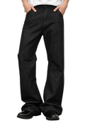 Ashlar Slim Bootcut — worn on model, black jeans breaking over black loafers