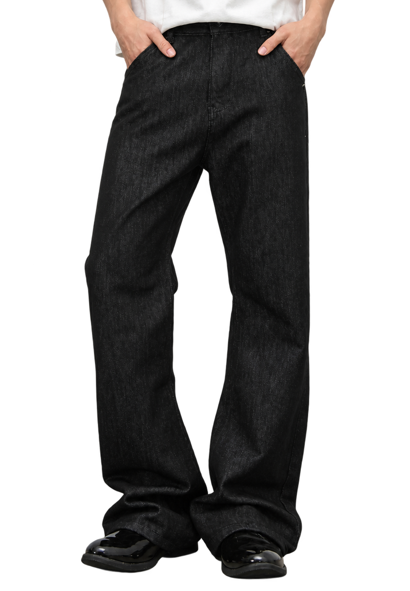 Ashlar Slim Bootcut — worn on model, black jeans breaking over black loafers