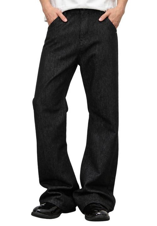 Ashlar Slim Bootcut — worn on model, black jeans breaking over black loafers
