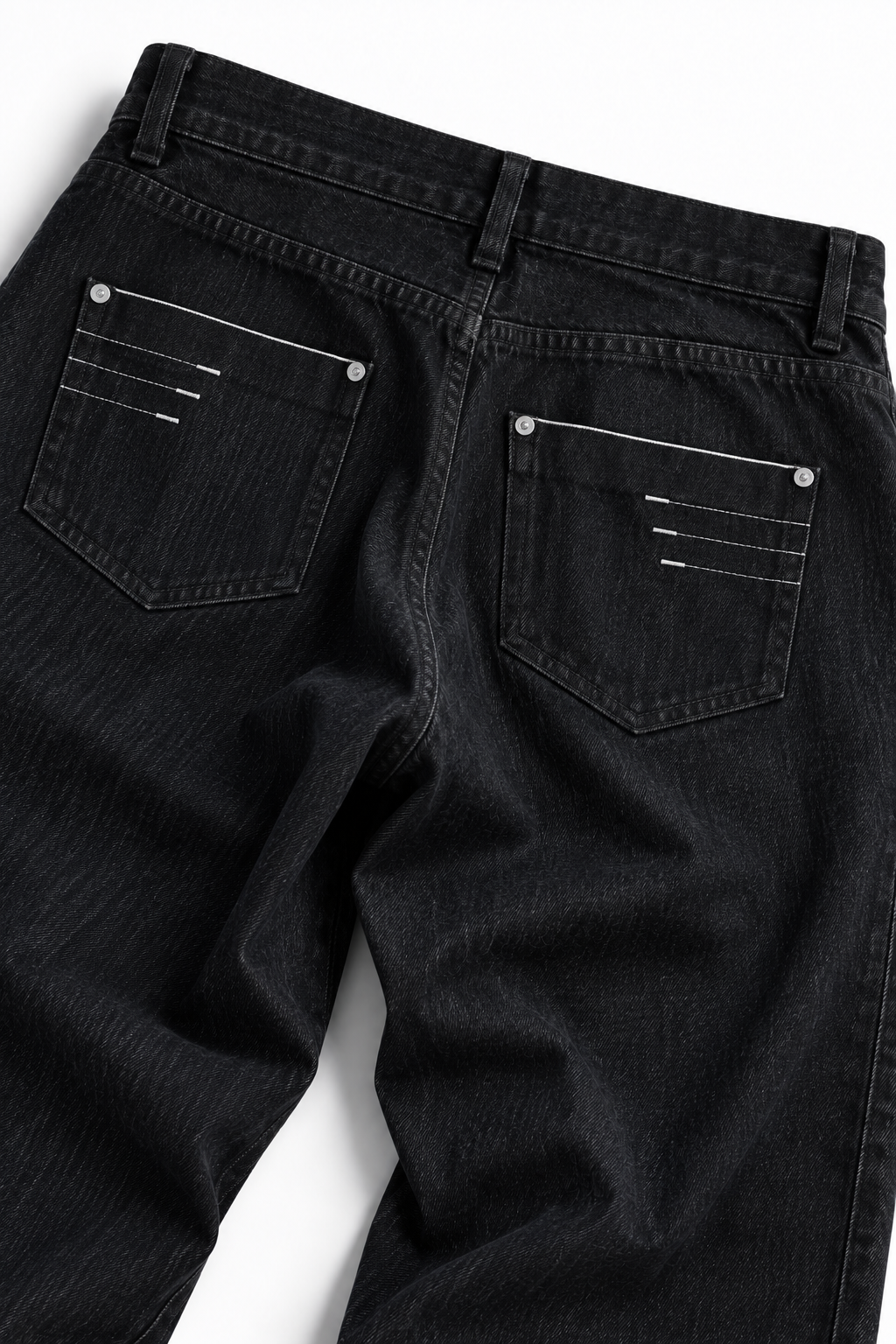Ashlar Slim Bootcut — back pocket detail with contrast stitching on black denim