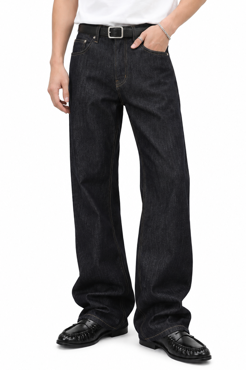 Scarp Loose Bootcut — worn on model with a belt, dark unfaded indigo jeans over black loafers