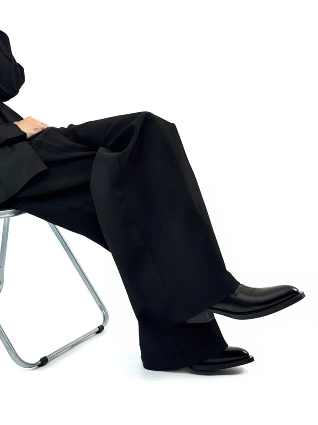 Talus Zip Boot — worn with wide black trousers, seated